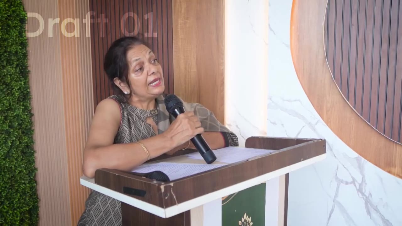A woman holding a microphone and speaking from a lectern