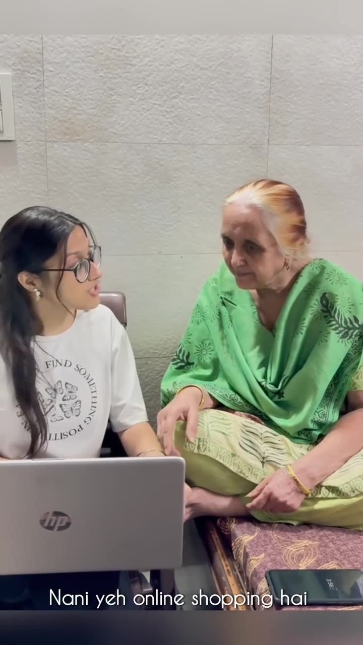 A young companion introducing an older woman to online shopping